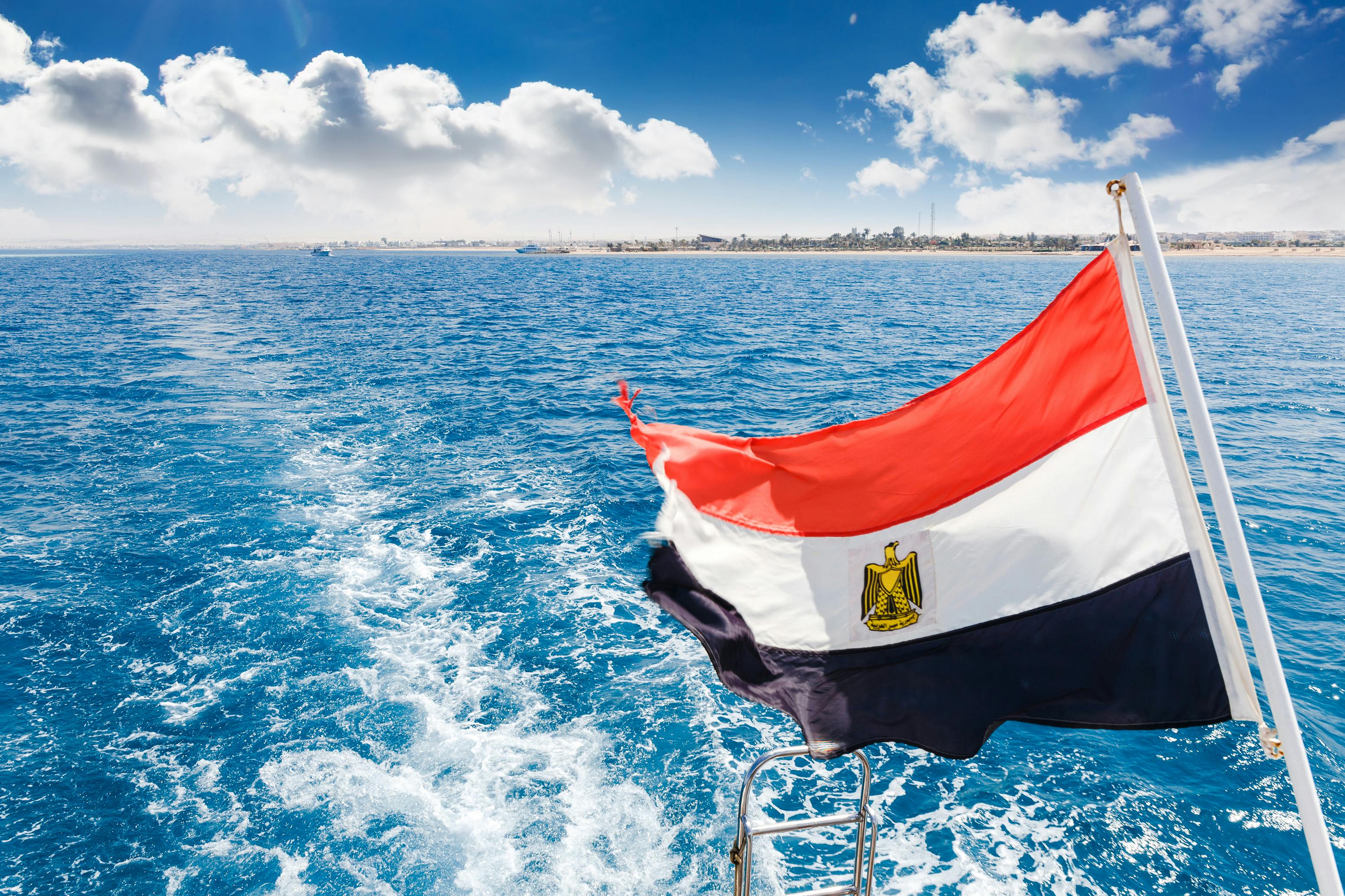 Our Egypt Tours - Egyptian Flag over Red Sea Waters with Beautiful Coastline