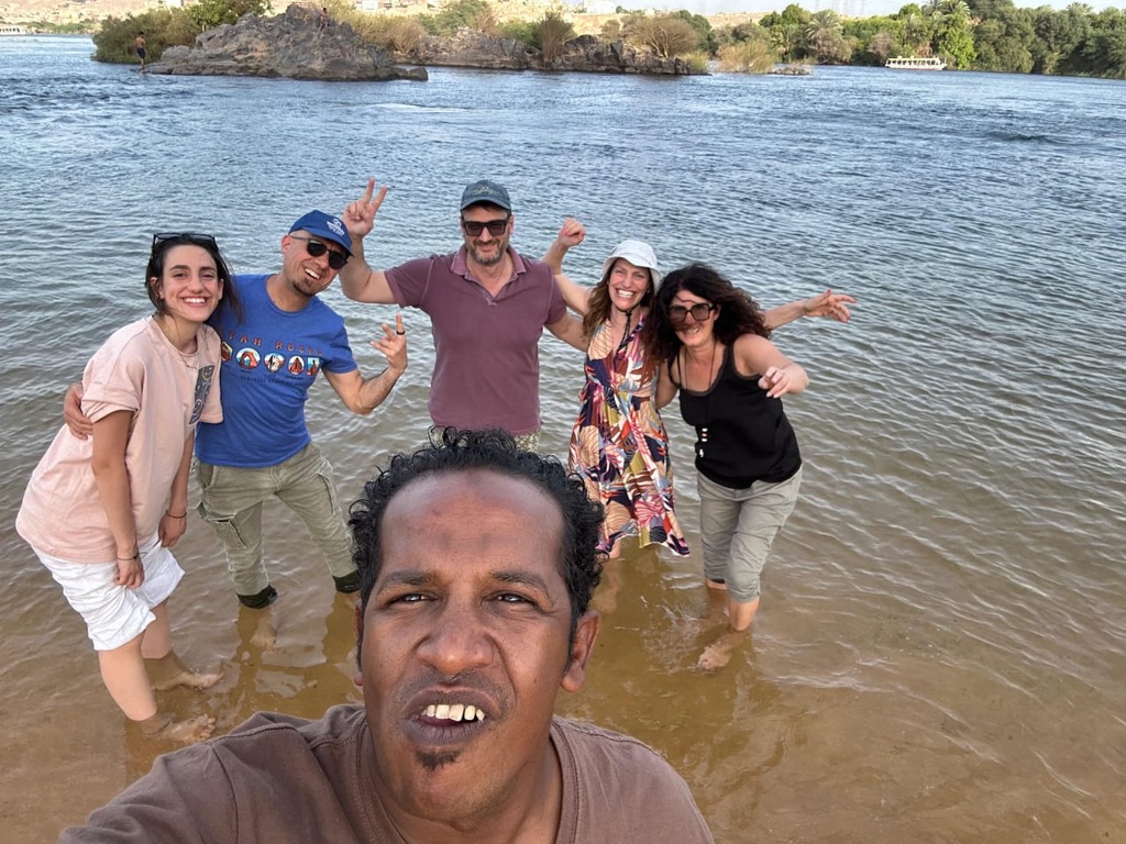 Fun group enjoying water experience on Nile River - joyful adventure with traditional boat