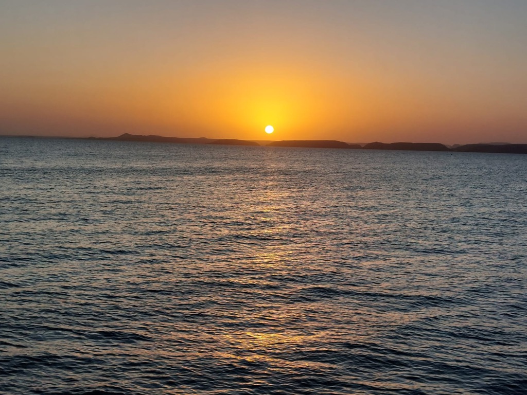 Golden sunset with water reflections showing natural beauty of Egypt - breathtaking landscape