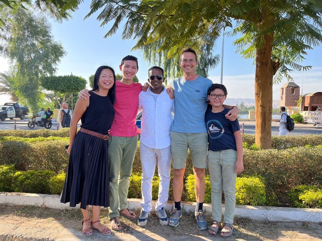 International family enjoying outdoor setting with palm trees - authentic Egyptian experience