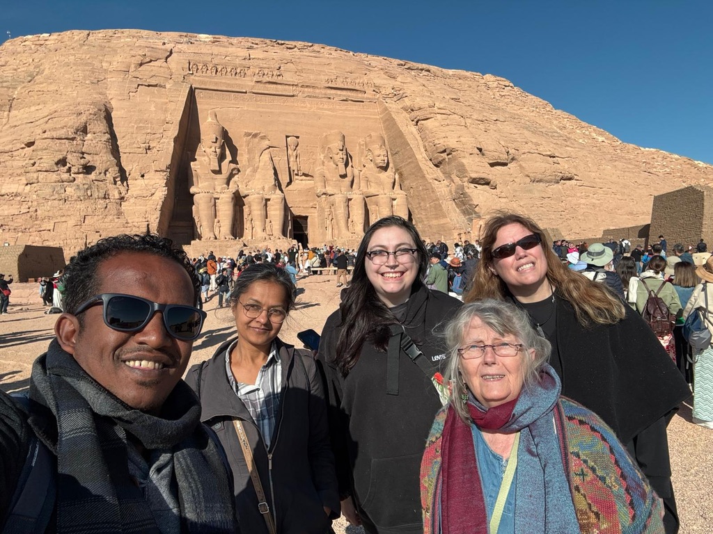 Mostafa with diverse group of senior travelers at Abu Simbel - inclusive travel experience