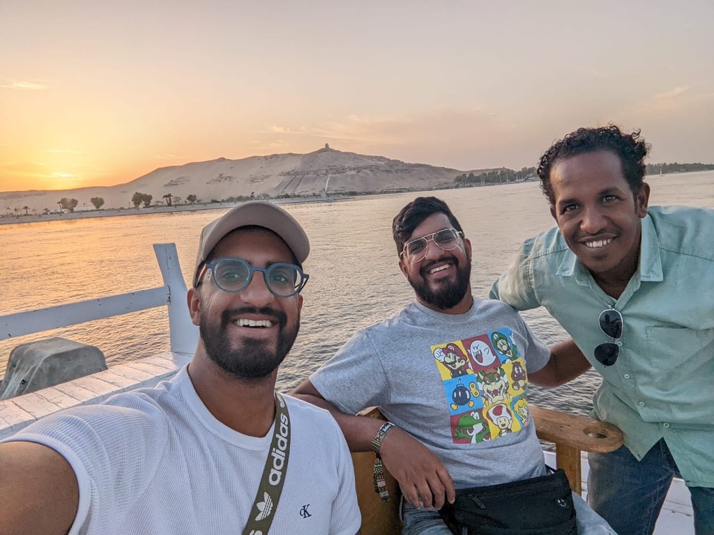 Three friends on Nile cruise during sunset - perfect friendship moment on the river
